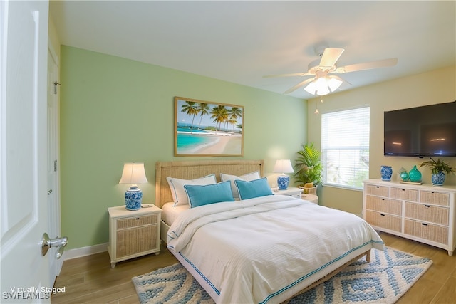 bedroom with ceiling fan and wood-type flooring