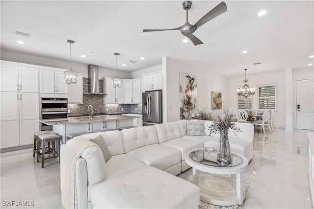 living room featuring ceiling fan and sink