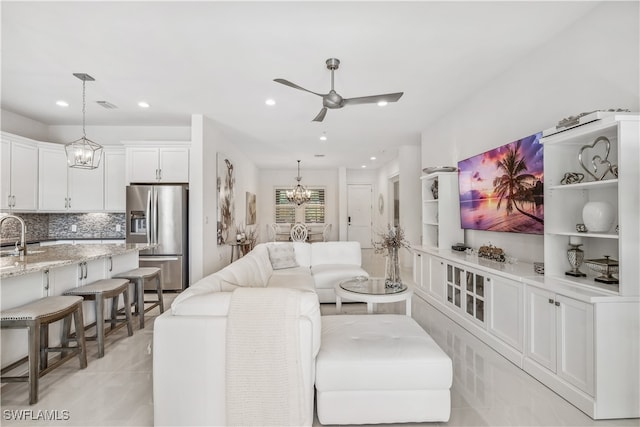 living room with ceiling fan and sink