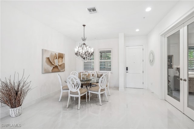 dining room with a healthy amount of sunlight and a notable chandelier