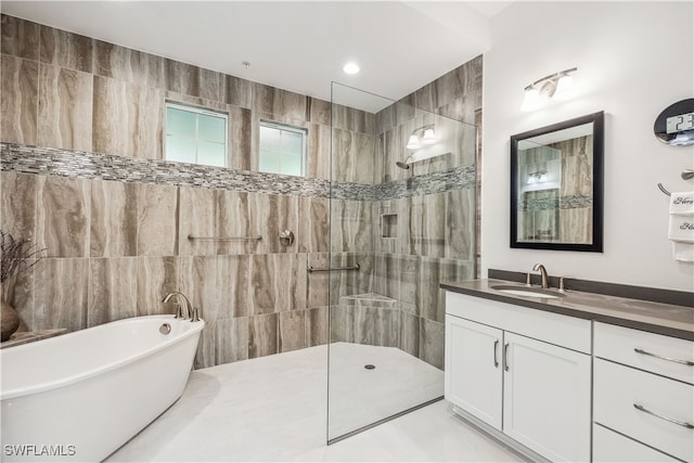 bathroom featuring vanity, tile walls, and independent shower and bath