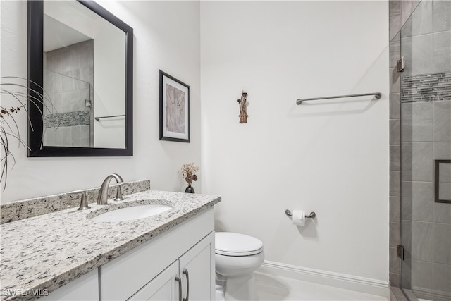 bathroom with vanity, toilet, and an enclosed shower