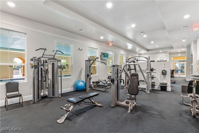 gym with a tray ceiling