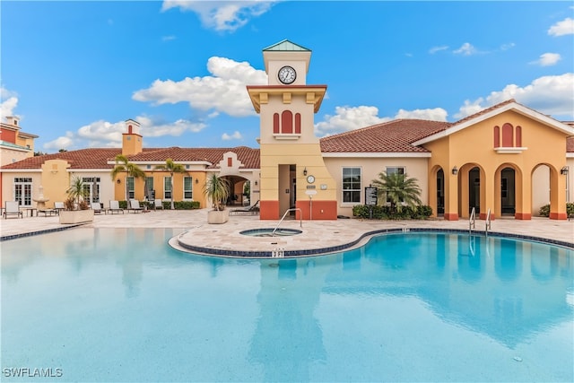 view of swimming pool with a patio area and a community hot tub