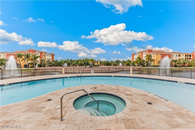 view of pool featuring an in ground hot tub