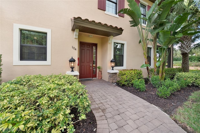 8757 Bellano Ct Unit 6-104, Naples, FL 34119 - property entrance featuring stucco siding
