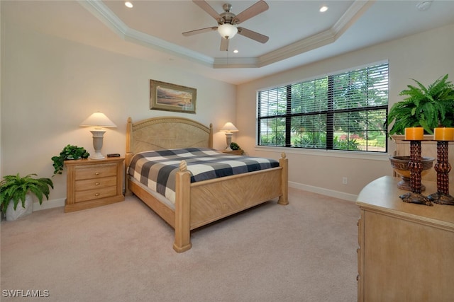 carpeted bedroom with ornamental molding, a raised ceiling, and ceiling fan