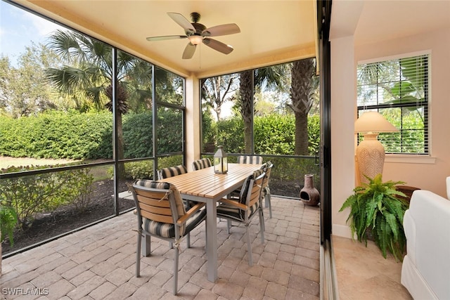 sunroom / solarium with a healthy amount of sunlight and ceiling fan