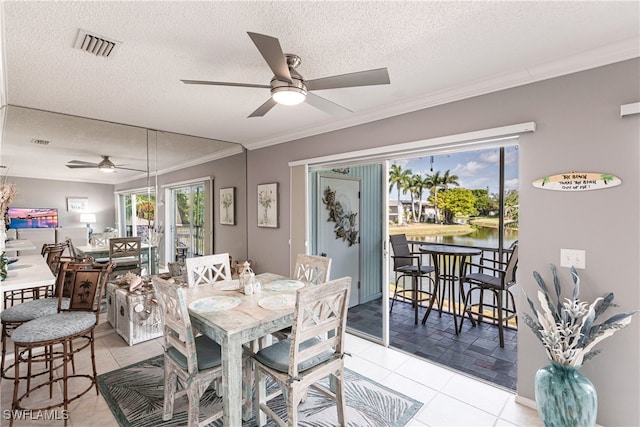 dining room featuring crown molding, a textured ceiling, light tile patterned floors, and ceiling fan