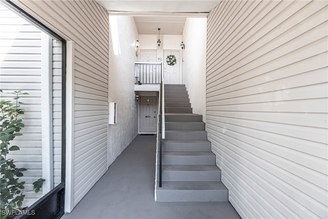 stairway featuring concrete flooring