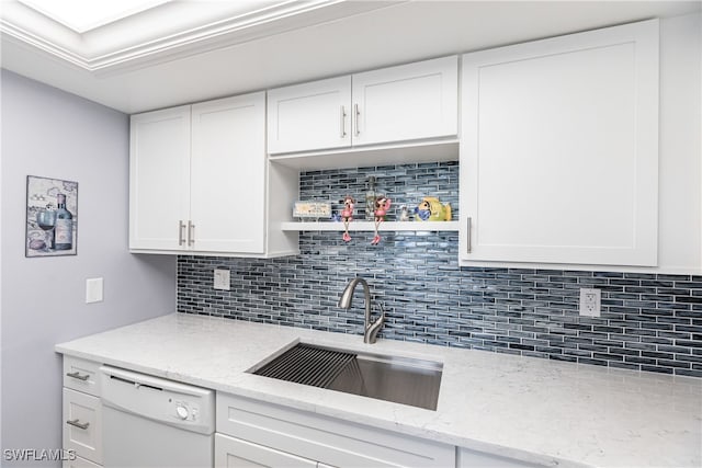 kitchen featuring sink, dishwasher, and white cabinetry