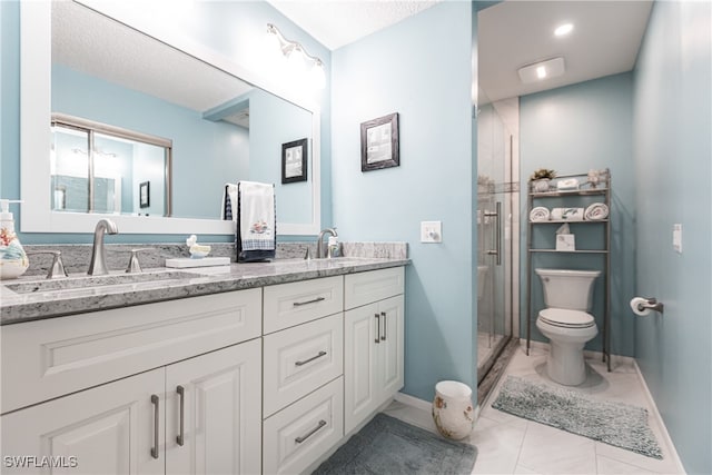 bathroom featuring vanity, tile patterned floors, toilet, and an enclosed shower