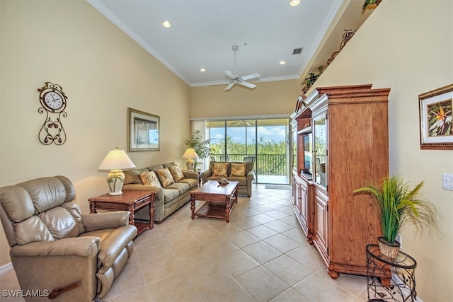 living room with crown molding, ceiling fan, a high ceiling, and light tile patterned floors