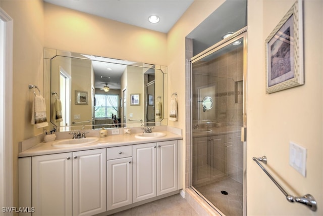 bathroom featuring vanity, walk in shower, tile patterned flooring, and ceiling fan