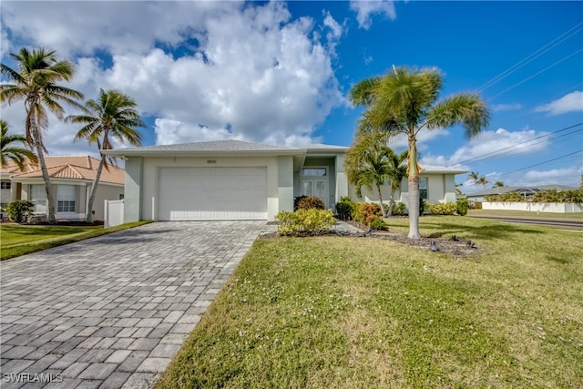 ranch-style home with a front yard and a garage