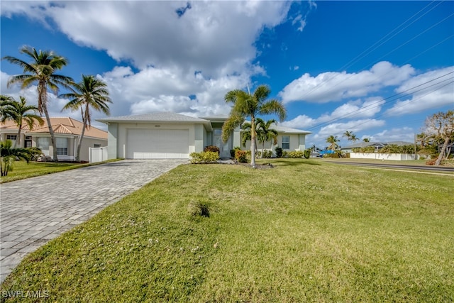 ranch-style home featuring a front lawn and a garage