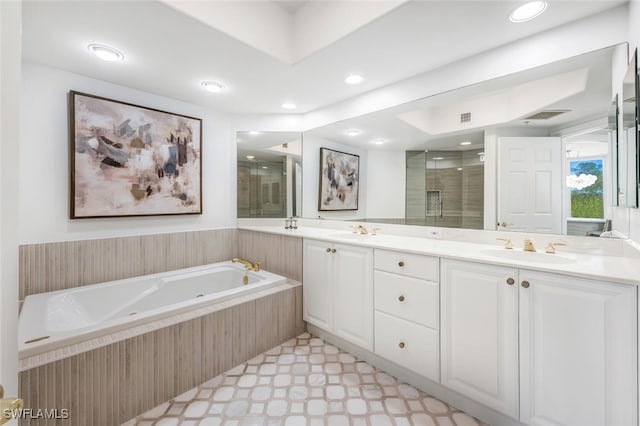 bathroom with tile patterned floors, a garden tub, a stall shower, and a sink