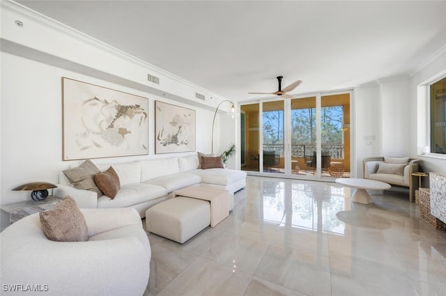 living room with a wall of windows, crown molding, a ceiling fan, and visible vents