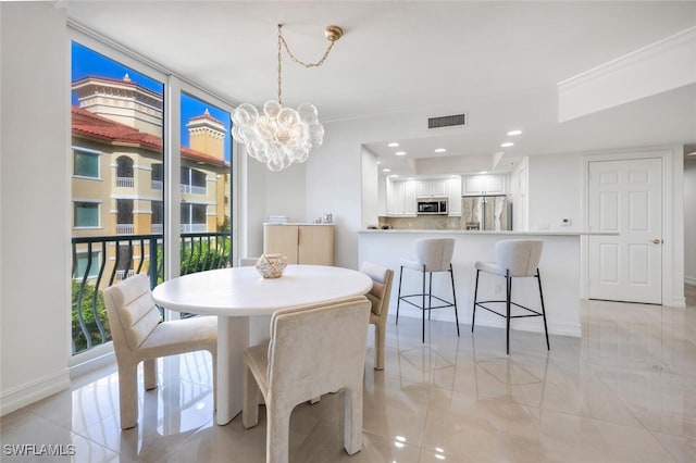 dining room featuring baseboards, visible vents, recessed lighting, floor to ceiling windows, and a notable chandelier