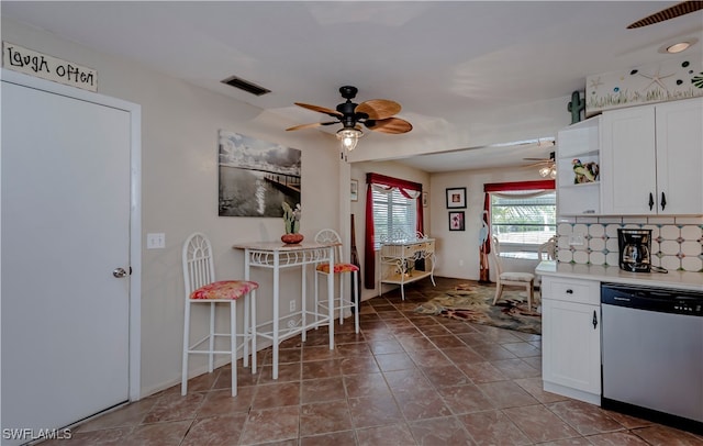 kitchen featuring white cabinetry, dishwasher, ceiling fan, tasteful backsplash, and light tile patterned floors