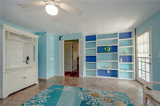 tiled bedroom with a closet and ceiling fan