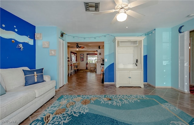 living room with tile patterned floors and ceiling fan