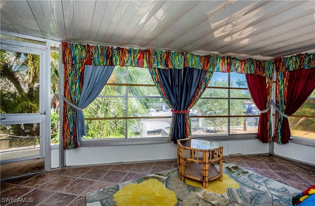 unfurnished sunroom featuring a wealth of natural light and wood ceiling