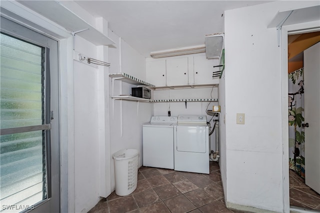 laundry room with a wealth of natural light, cabinets, and washer and dryer