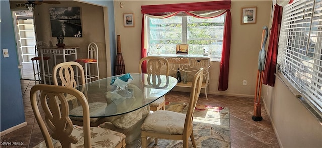 dining area with dark tile patterned floors