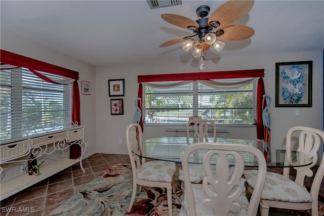 tiled dining room featuring a wealth of natural light and ceiling fan