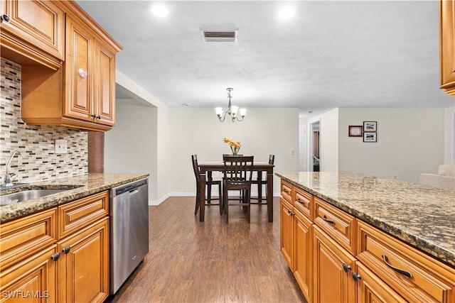 kitchen with stone countertops, decorative light fixtures, stainless steel dishwasher, and dark hardwood / wood-style floors