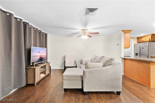 living room featuring dark wood-type flooring and ceiling fan