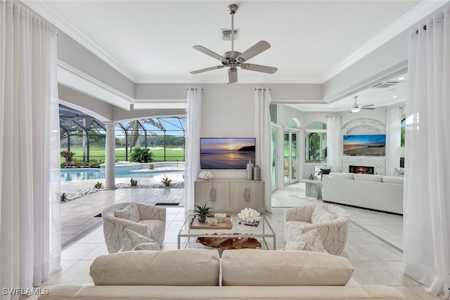 tiled living room featuring ceiling fan and crown molding