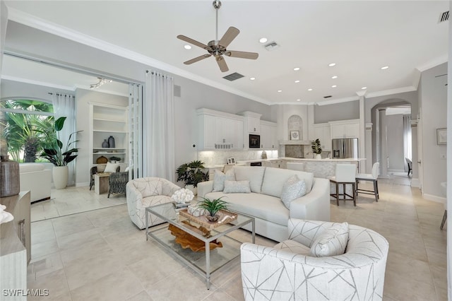 tiled living room featuring ceiling fan and crown molding