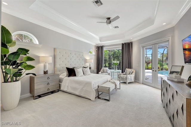 carpeted bedroom with french doors, a tray ceiling, ornamental molding, ceiling fan, and access to exterior