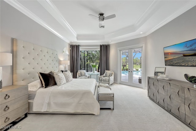 carpeted bedroom featuring a raised ceiling, french doors, crown molding, ceiling fan, and access to exterior