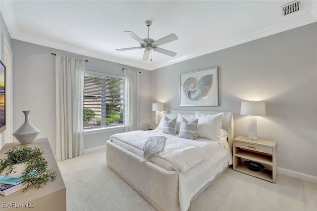 bedroom with light carpet, ceiling fan, and ornamental molding