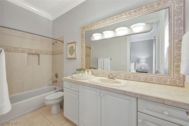 full bathroom featuring toilet, tile patterned floors, crown molding, tiled shower / bath, and vanity