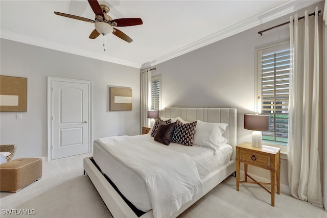 carpeted bedroom featuring ceiling fan and ornamental molding