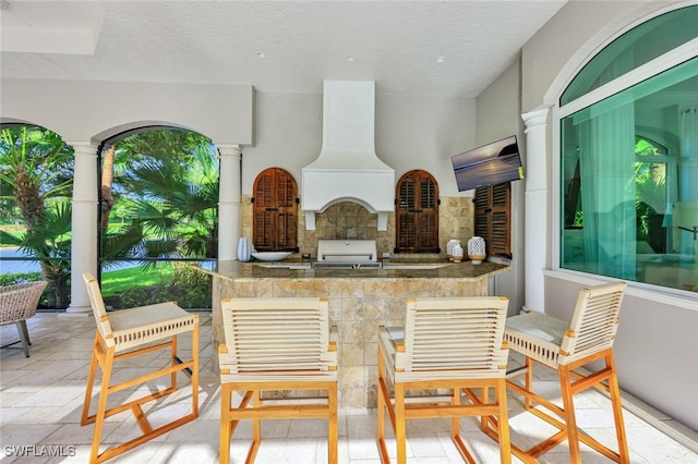 view of patio featuring a grill and an outdoor kitchen