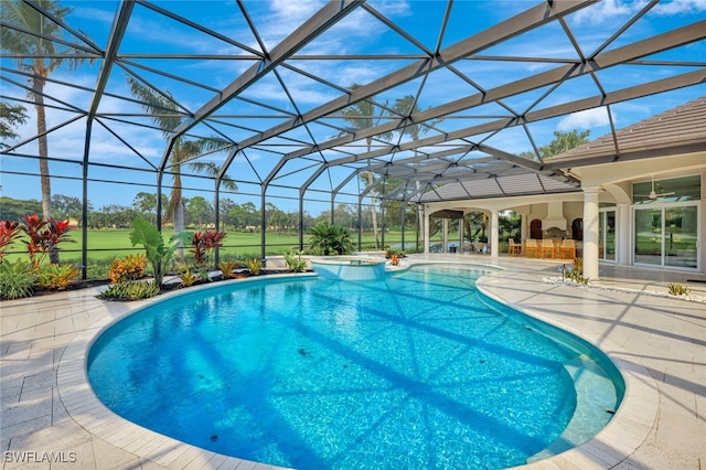 view of pool featuring ceiling fan, glass enclosure, an in ground hot tub, and a patio area