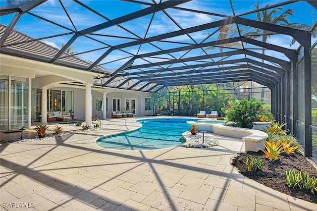 view of pool with a patio area, a lanai, and a jacuzzi