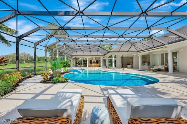 view of swimming pool with a lanai and a patio