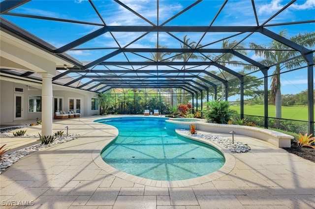 view of pool with a lanai, a patio, and an in ground hot tub