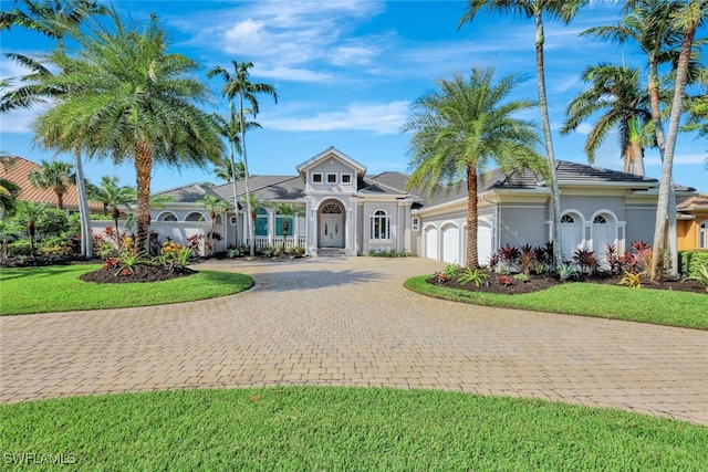 view of front of property featuring a front yard and a garage