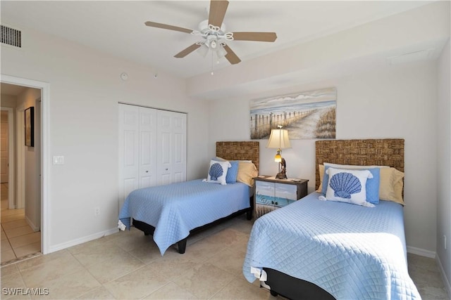 bedroom featuring ceiling fan, a closet, and light tile patterned floors