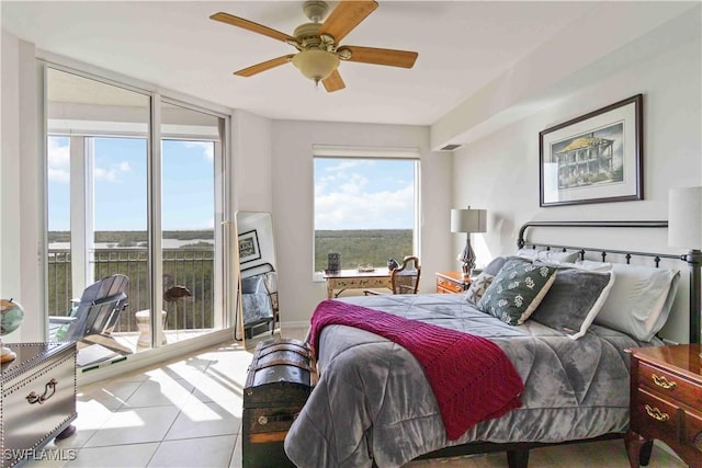 tiled bedroom with ceiling fan and access to outside