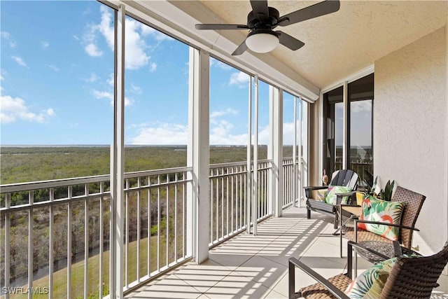 unfurnished sunroom featuring ceiling fan