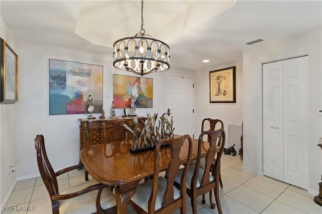 tiled dining room with a chandelier