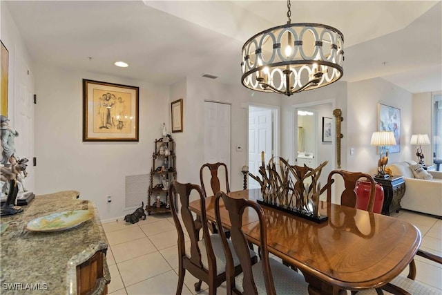 dining area with light tile patterned floors and an inviting chandelier